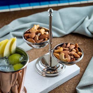 Handcrafted chrome-plated copper double bowl stand with a sleek, polished finish. Features two symmetrical bowls for serving snacks, nuts, or small accompaniments. Perfect for casual or elegant dining presentations.