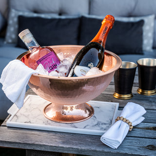 Handmade hammered copper champagne bowl with a polished, wide design and elevated base, ideal for chilling champagne, wine, and spirits. Perfect as a stylish cooler and elegant table centerpiece for gatherings and events.