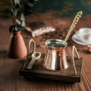 Handmade hammered copper Turkish coffee pot (cezve) with an ornate brass handle, designed for brewing rich, aromatic Turkish, Greek, and Arabic coffee.