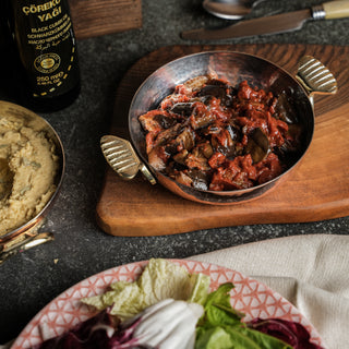 Handcrafted Turkish copper frying pan (sahan) with a hammered finish and fish-shaped brass handles. Made from pure copper with a tin lining for even cooking.