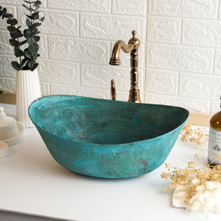 Handmade green copper vessel sink with a hammered finish, unique patina, and included drain cap, available in sizes 14"–20", ideal for bathroom vanity installations.