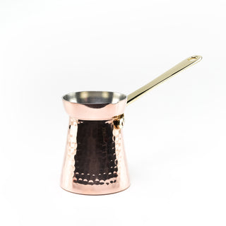 Hand-hammered copper Turkish coffee pot with a polished finish, brass handle, and tin-lined interior, designed for even heat distribution and brewing 2-3 servings of Turkish coffee.