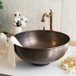 Handmade dark copper vessel sink with a hammered finish, available in sizes 8" to 18", ideal for kitchen and bathroom vanities. Includes a drain cap.