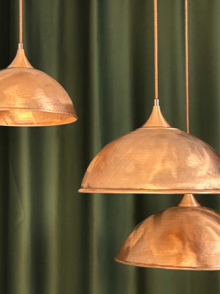 Handmade matte copper pendant light with a rustic finish, available in multiple sizes (6"–16"), featuring solid copper fittings and customizable accessories for easy installation.