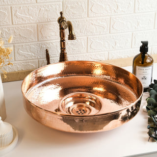 Handmade hammered copper sink with a round vessel design, polished finish, and artisanal craftsmanship. Perfect for bathroom or kitchen use.