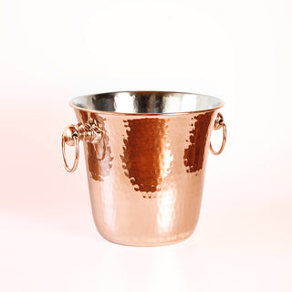 Handmade hammered copper ice bucket with a solid copper finish, brass handles, and tin-lined interior, ideal for chilling wine, champagne, or spirits.