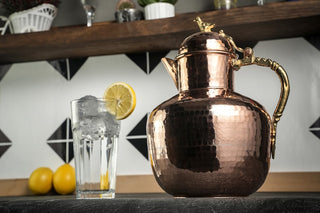 Handmade heavy-duty solid copper pitcher with a polished finish, designed as a 2000ml water and beverage jug for an elegant dining experience.