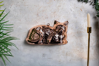 Copper cake mold, cat baking mold, copper kitchen decor, handcrafted bakeware, cat-shaped mold, copper kitchen wall art, decorative copper mold, unique baking mold, food-safe copper mold, copper kitchen accessories.







