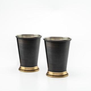 Set of two dark copper tumblers with a matte blackened finish, brass detailing at the base, and a 400ml capacity, ideal for cocktails, mocktails, or cold drinks.