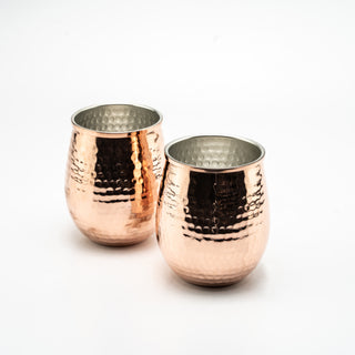 Set of two hand-hammered solid copper stemless glasses with a textured finish, 450ml capacity, ideal for serving cocktails, wine, or chilled beverages.