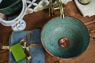 Handmade copper vessel sink with a natural green or blue patina finish, available in multiple sizes, featuring a hammered texture and farmhouse-style design.